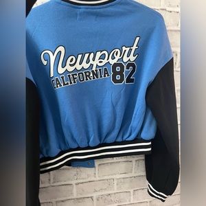 Baby blue and black Varsity cropped sweater